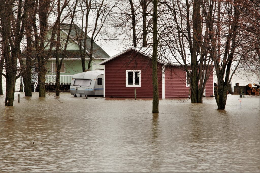 A Red and Green House Surrounded with Water