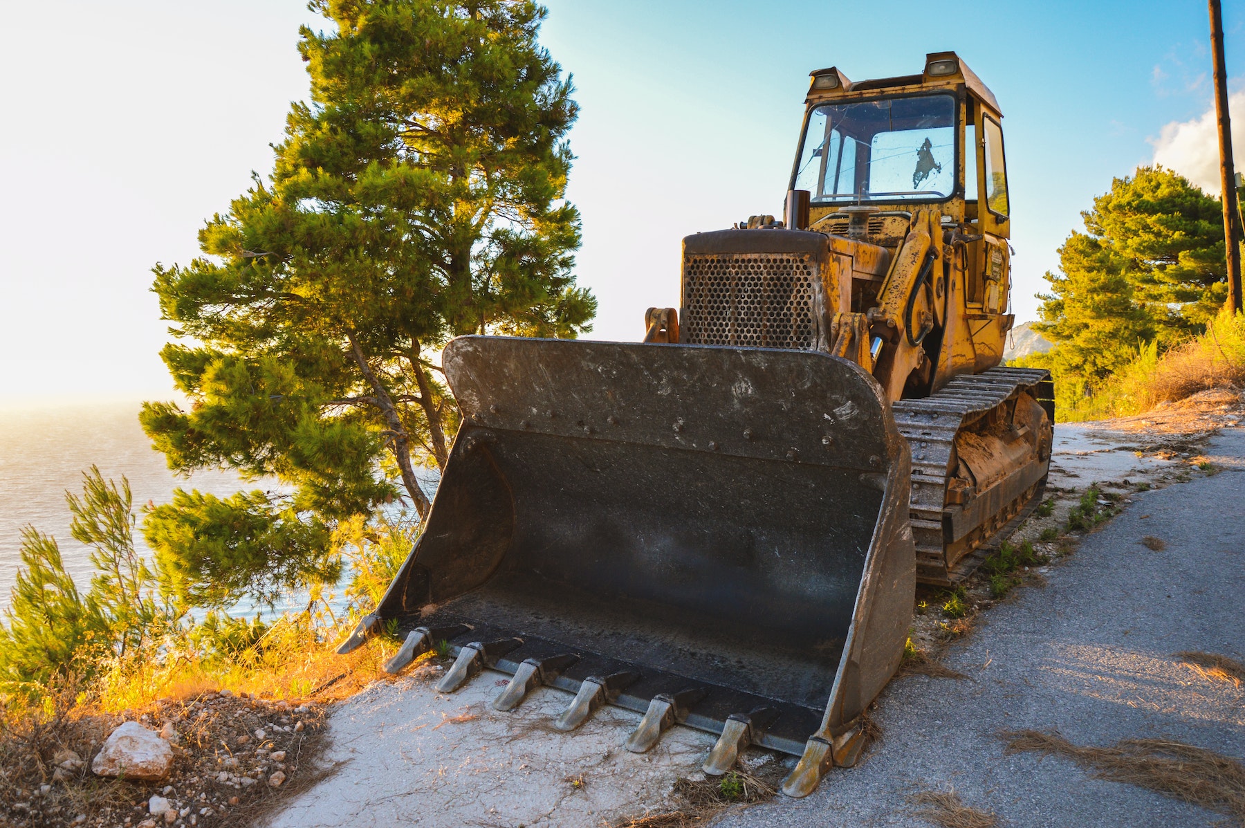 Yellow and Black Front Loader on Roadside